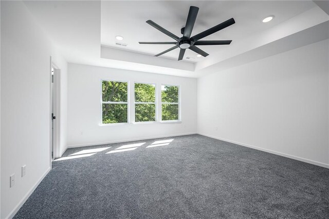 11147 Rowland Ave, Kansas City, KS 66109 - carpeted spare room with a ceiling fan, recessed lighting, a tray ceiling, and baseboards