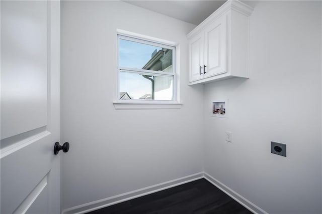11147 Rowland Ave, Kansas City, KS 66109 - washroom with electric dryer hookup, washer hookup, baseboards, dark wood-type flooring, and cabinet space