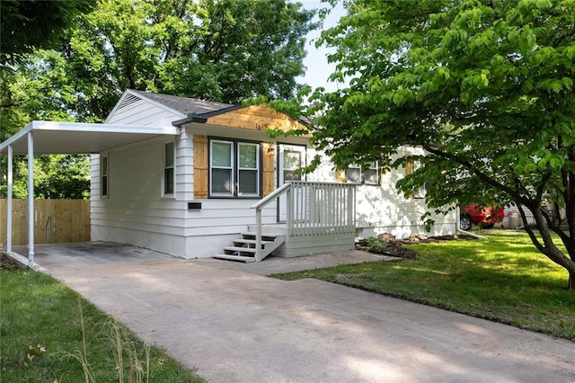 1617 N Pearl St, Independence, MO 64050 - view of front facade featuring concrete driveway and a carport