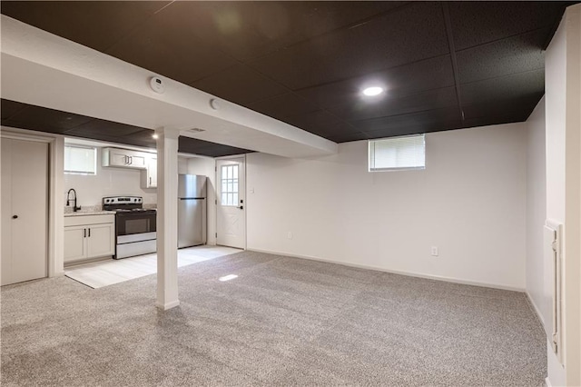 1617 N Pearl St, Independence, MO 64050 - below grade area with freestanding refrigerator and light carpet