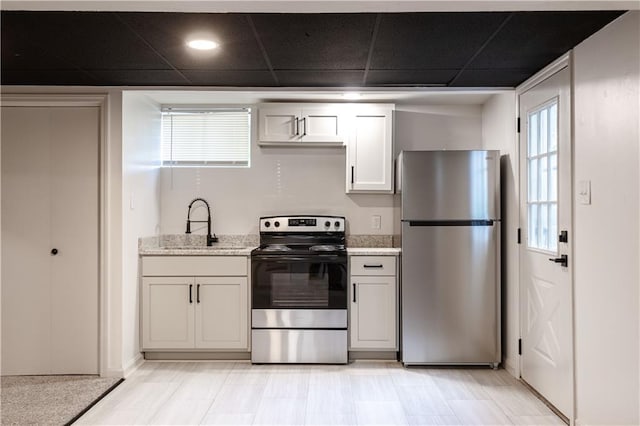 1617 N Pearl St, Independence, MO 64050 - kitchen featuring stainless steel appliances and light stone counters