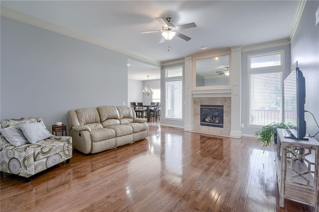 8905 NE 101st St, Kansas City, MO 64157 - living room with a ceiling fan, crown molding, wood finished floors, baseboards, and a fireplace