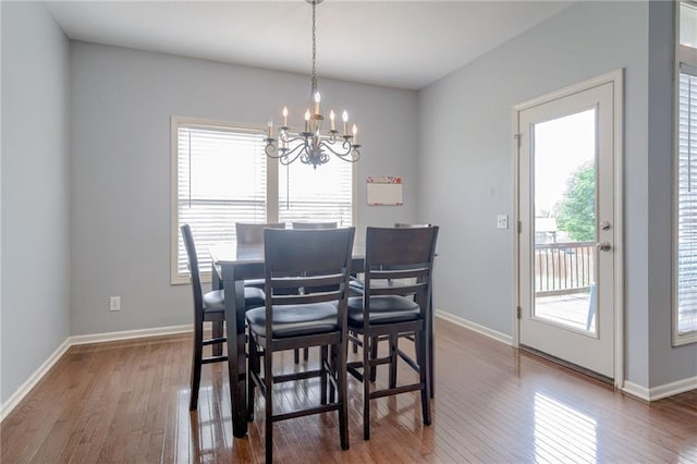 8905 NE 101st St, Kansas City, MO 64157 - dining space featuring a chandelier, hardwood / wood-style flooring, and baseboards