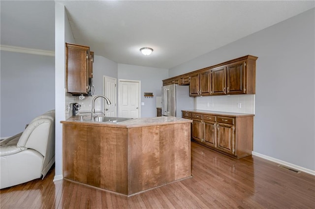 8905 NE 101st St, Kansas City, MO 64157 - kitchen with freestanding refrigerator, a sink, wood finished floors, light countertops, and baseboards