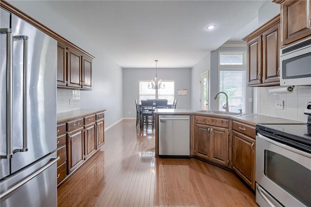 8905 NE 101st St, Kansas City, MO 64157 - kitchen featuring stainless steel appliances, a sink, hardwood / wood-style flooring, recessed lighting, and baseboards