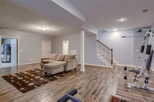 8905 NE 101st St, Kansas City, MO 64157 - living area featuring wood finished floors, baseboards, and stairs