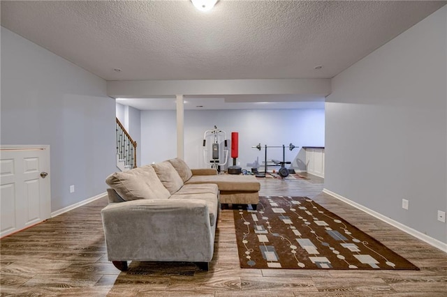 8905 NE 101st St, Kansas City, MO 64157 - living room with wood finished floors, a textured ceiling, stairs, and baseboards
