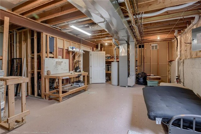 8905 NE 101st St, Kansas City, MO 64157 - unfinished basement with water heater, a workshop area, and heating unit