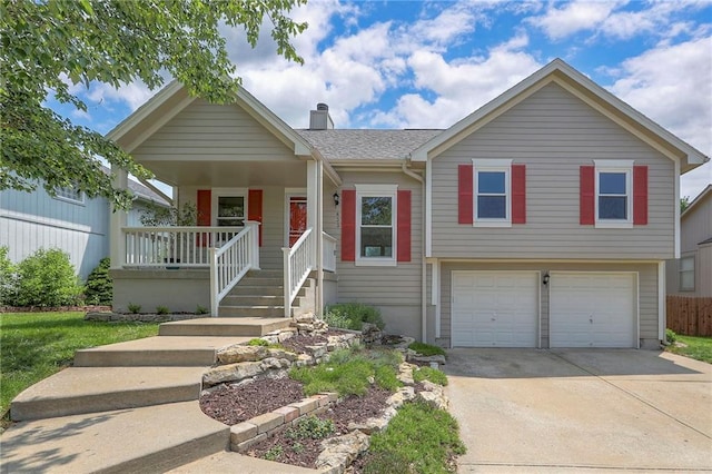 833 SW Harvest Dr, Grain Valley, MO 64029 - view of front facade with an attached garage, covered porch, a chimney, and concrete driveway