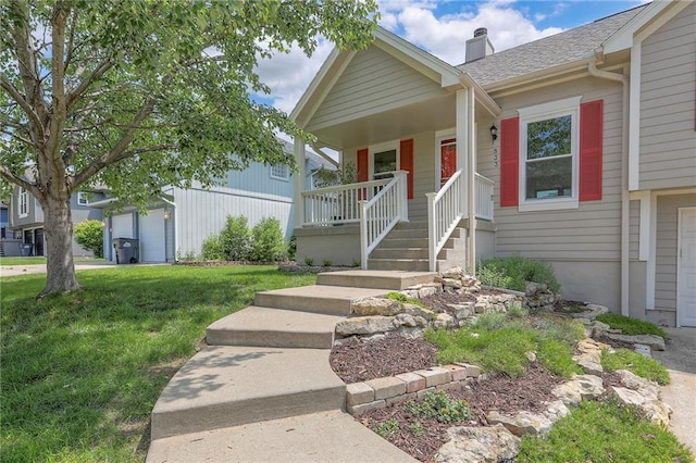 833 SW Harvest Dr, Grain Valley, MO 64029 - view of front facade with covered porch, a chimney, a garage, a front yard, and a shingled roof