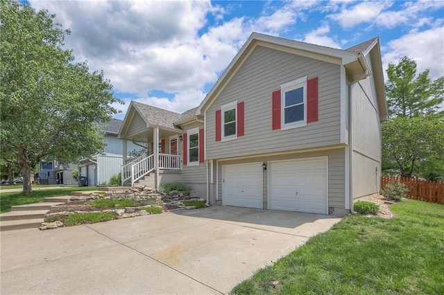 833 SW Harvest Dr, Grain Valley, MO 64029 - view of front of house featuring an attached garage, driveway, and covered porch