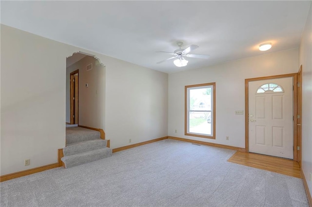 833 SW Harvest Dr, Grain Valley, MO 64029 - foyer featuring light carpet, ceiling fan, baseboards, and stairway