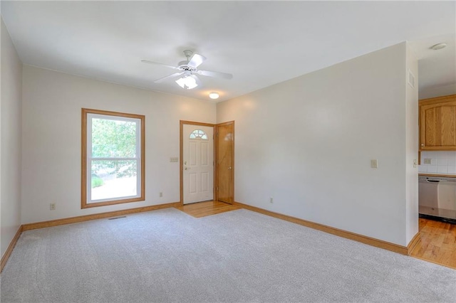 833 SW Harvest Dr, Grain Valley, MO 64029 - foyer with a ceiling fan, light carpet, and baseboards