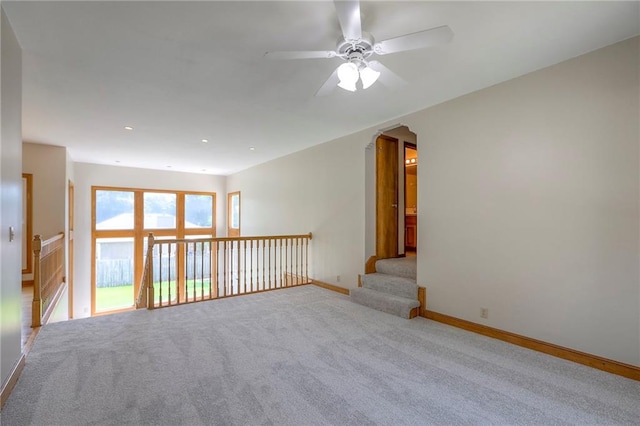 833 SW Harvest Dr, Grain Valley, MO 64029 - carpeted empty room with ceiling fan, arched walkways, and baseboards