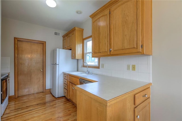 833 SW Harvest Dr, Grain Valley, MO 64029 - kitchen with a sink, freestanding refrigerator, electric range, tasteful backsplash, and light countertops