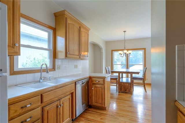 833 SW Harvest Dr, Grain Valley, MO 64029 - kitchen with stainless steel dishwasher, a sink, plenty of natural light, and tasteful backsplash