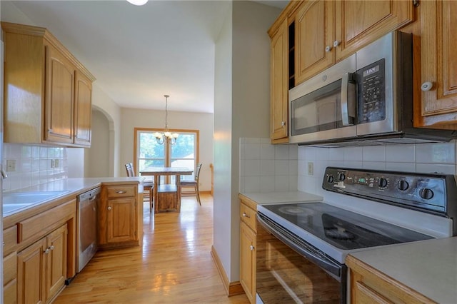833 SW Harvest Dr, Grain Valley, MO 64029 - kitchen featuring stainless steel appliances, light wood-style flooring, light countertops, and a chandelier