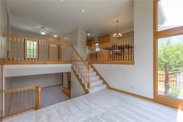 833 SW Harvest Dr, Grain Valley, MO 64029 - stairs with carpet floors, a ceiling fan, healthy amount of natural light, and a chandelier