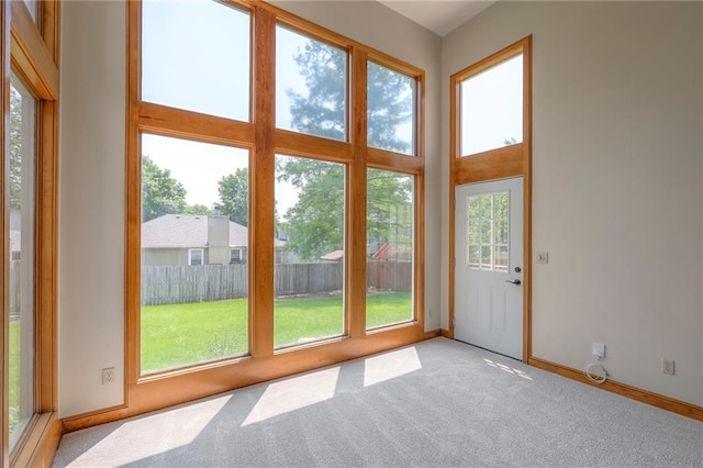 833 SW Harvest Dr, Grain Valley, MO 64029 - doorway to outside featuring light carpet and baseboards