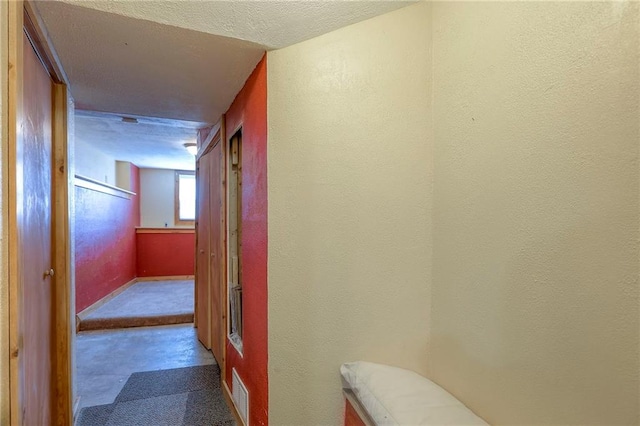 833 SW Harvest Dr, Grain Valley, MO 64029 - hallway with a textured wall, a textured ceiling, and baseboards