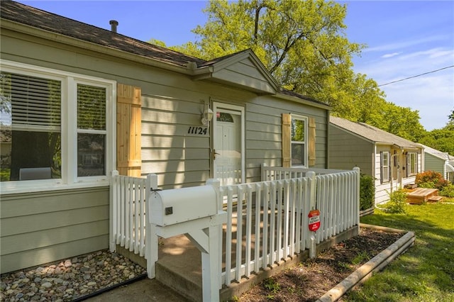11124 W 69th Ter, Shawnee, KS 66203 - view of exterior entry with a deck