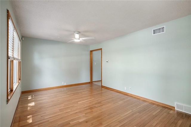 11124 W 69th Ter, Shawnee, KS 66203 - empty room with a ceiling fan, light wood finished floors, baseboards, and a textured ceiling