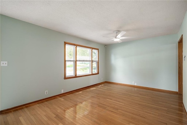 11124 W 69th Ter, Shawnee, KS 66203 - empty room featuring light wood finished floors, a ceiling fan, a textured ceiling, and baseboards
