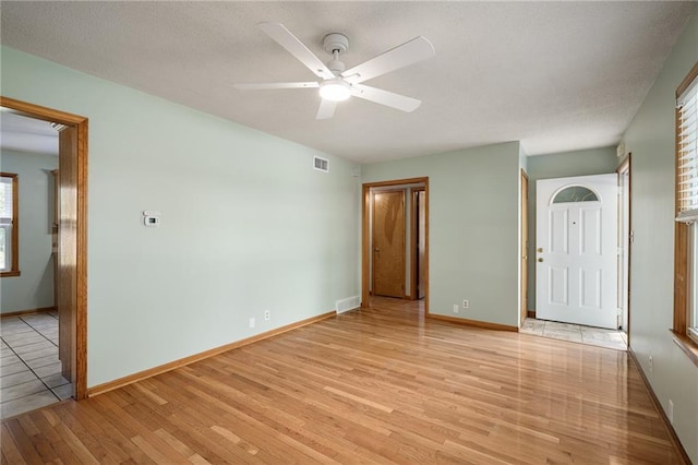 11124 W 69th Ter, Shawnee, KS 66203 - empty room with light wood finished floors, a ceiling fan, and baseboards