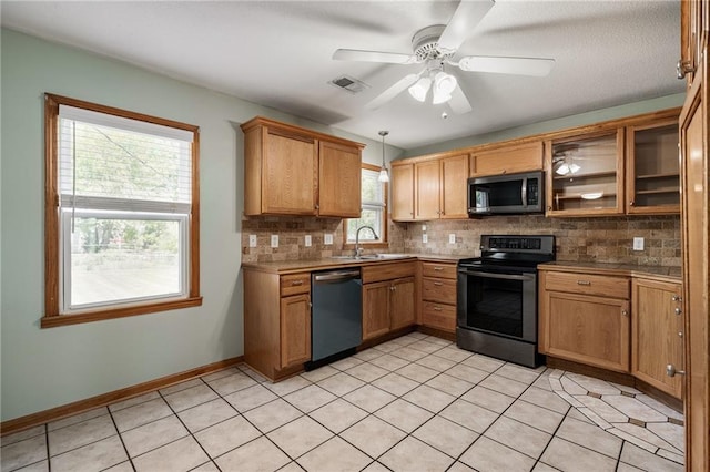 11124 W 69th Ter, Shawnee, KS 66203 - kitchen featuring stainless steel appliances, a sink, backsplash, and light tile patterned floors