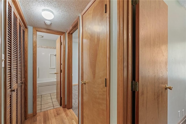 11124 W 69th Ter, Shawnee, KS 66203 - corridor with a textured ceiling and light wood-type flooring