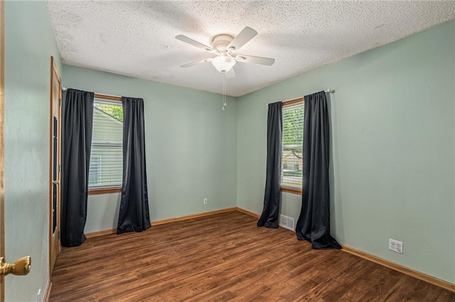 11124 W 69th Ter, Shawnee, KS 66203 - empty room featuring wood finished floors, plenty of natural light, a ceiling fan, baseboards, and a textured ceiling