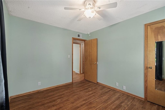 11124 W 69th Ter, Shawnee, KS 66203 - unfurnished bedroom featuring wood finished floors, a textured ceiling, baseboards, and ceiling fan