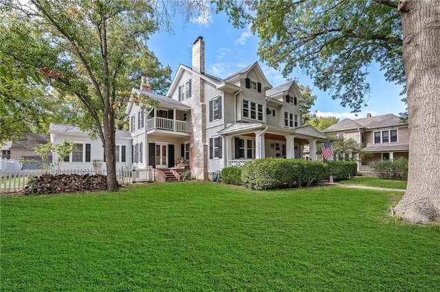 424 S Elm St, Ottawa, KS 66067 - rear view of house featuring a balcony and a chimney