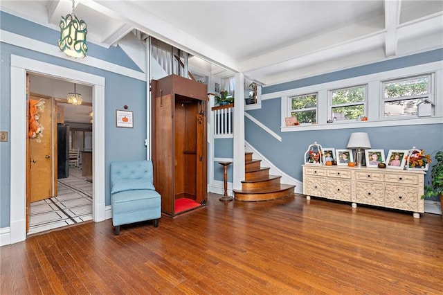 424 S Elm St, Ottawa, KS 66067 - living area featuring beam ceiling, hardwood / wood-style floors, stairs, and baseboards