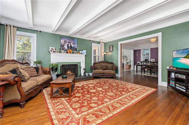 424 S Elm St, Ottawa, KS 66067 - living area with beam ceiling, wood finished floors, a lit fireplace, and baseboards