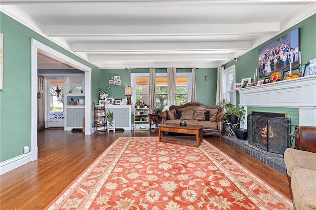 424 S Elm St, Ottawa, KS 66067 - living area with beamed ceiling, wood finished floors, a brick fireplace, and baseboards