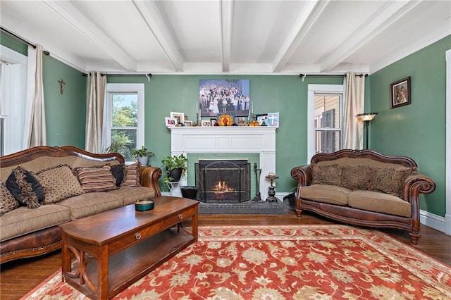 424 S Elm St, Ottawa, KS 66067 - living room featuring beam ceiling, wood finished floors, a brick fireplace, and baseboards