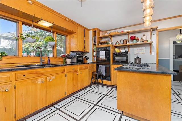 424 S Elm St, Ottawa, KS 66067 - kitchen with a sink, open shelves, stainless steel gas stovetop, brown cabinetry, and dark stone counters