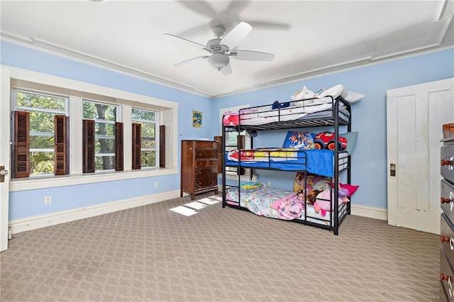 424 S Elm St, Ottawa, KS 66067 - carpeted bedroom with baseboards, crown molding, and a ceiling fan