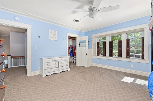 424 S Elm St, Ottawa, KS 66067 - bedroom featuring carpet, a walk in closet, baseboards, ornamental molding, and a closet