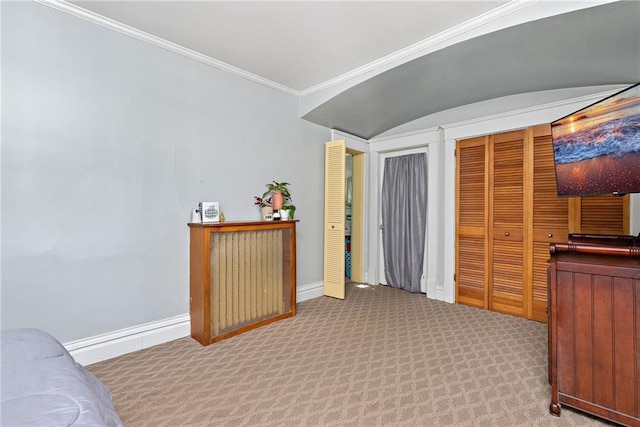 424 S Elm St, Ottawa, KS 66067 - carpeted bedroom featuring baseboards, ornamental molding, and multiple closets