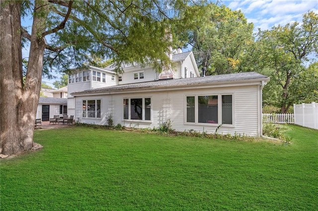 424 S Elm St, Ottawa, KS 66067 - back of property featuring a shingled roof and a patio