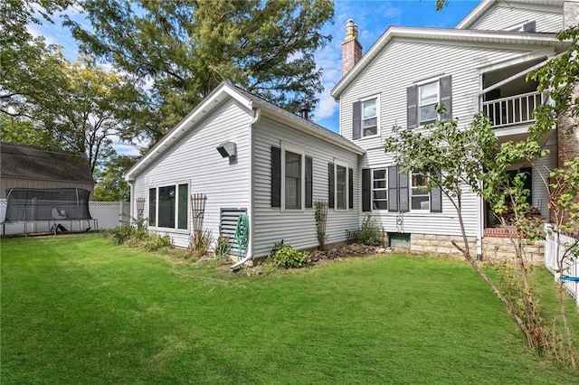 424 S Elm St, Ottawa, KS 66067 - view of side of property with a chimney and a lawn
