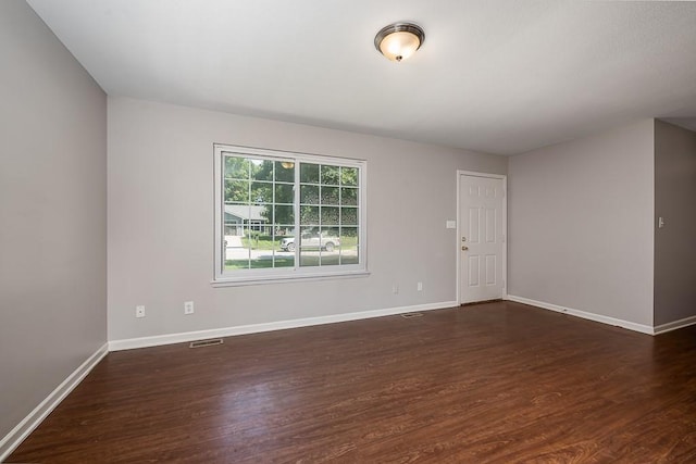 1180 Greenwood Pkwy, Tonganoxie, KS 66086 - empty room with dark wood-type flooring and baseboards