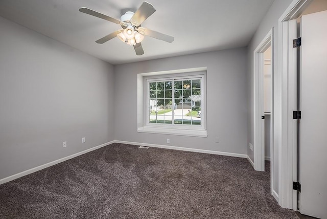 1180 Greenwood Pkwy, Tonganoxie, KS 66086 - unfurnished room with dark colored carpet, ceiling fan, and baseboards
