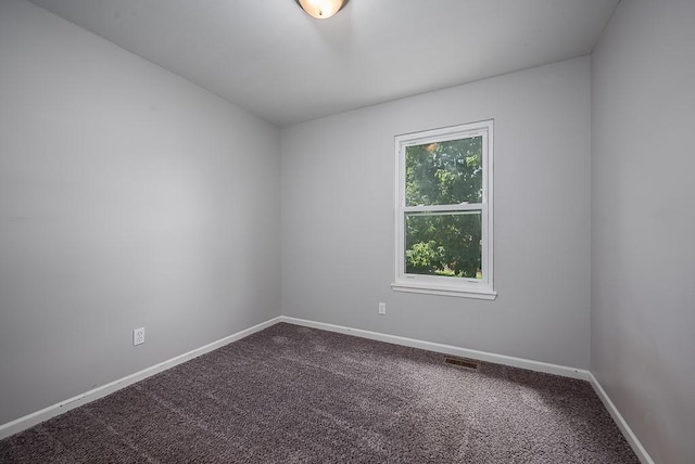 1180 Greenwood Pkwy, Tonganoxie, KS 66086 - spare room featuring dark carpet and baseboards