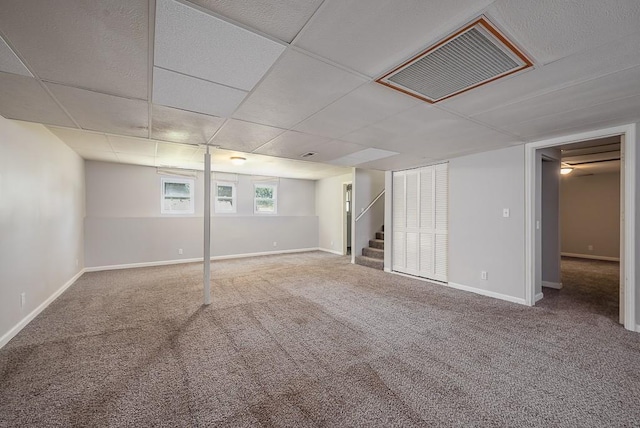 1180 Greenwood Pkwy, Tonganoxie, KS 66086 - below grade area featuring carpet floors, stairway, and baseboards