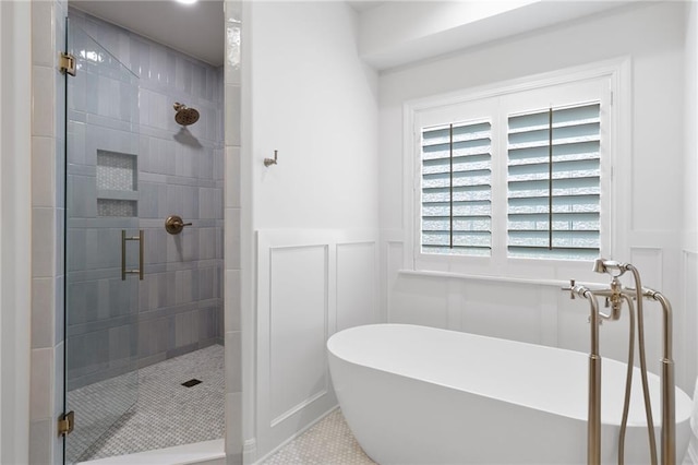 4424 NE Shadow Valley Cir, Lees Summit, MO 64064 - bathroom featuring a shower stall, a soaking tub, a decorative wall, a wainscoted wall, and tile patterned floors