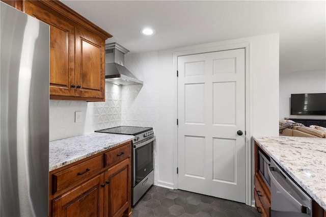 4424 NE Shadow Valley Cir, Lees Summit, MO 64064 - kitchen featuring stainless steel appliances, wall chimney exhaust hood, light stone counters, tasteful backsplash, and brown cabinetry
