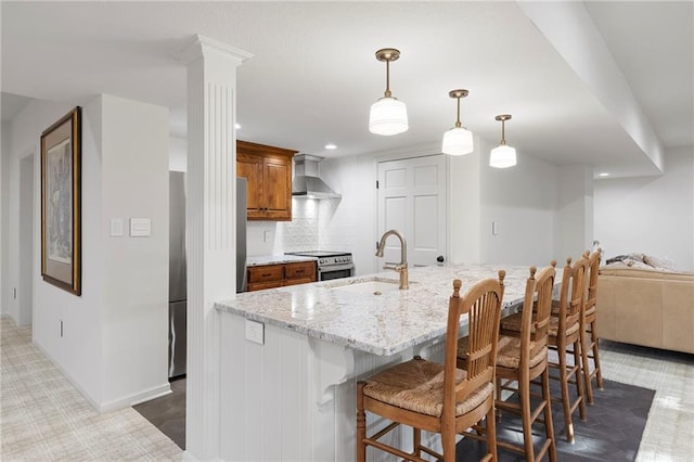 4424 NE Shadow Valley Cir, Lees Summit, MO 64064 - kitchen featuring wall chimney exhaust hood, a sink, stainless steel electric range oven, a breakfast bar area, and brown cabinetry